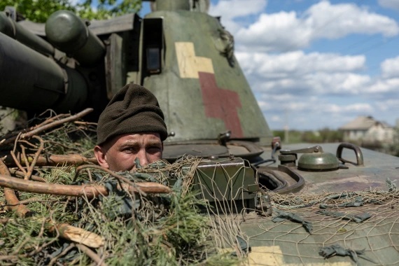 An Ukrainian soldier looks out from a tank in the frontline city of Lyman, Donetsk region in April 2022. [File: Jorge Silva//Reuters]